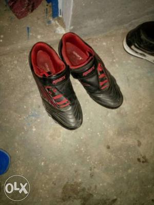Pair Of Black And Red Athletic Shoes