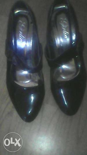 Pair Of Black Leather Heeled Shoes