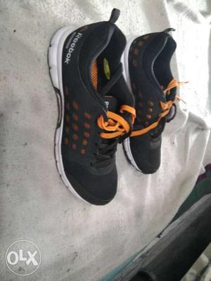 Pair Of Black-orange-and-white Reebok Shoes