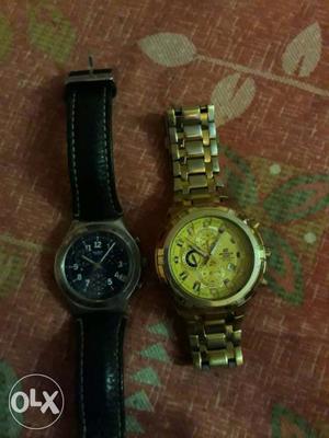 Two Round Silver And Gold Chronograph Watches