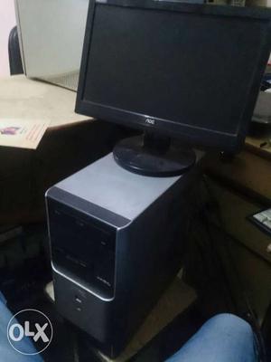 AOC Flat Screen Computer Monitor With Gray Computer Tower