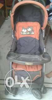 Baby's Green And Orange Stroller