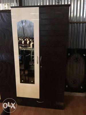 Brown And White Wooden Closet With Mirror