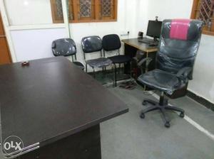Brown Wooden Desk;Black Office Rolling Chair; 3 chairs and a