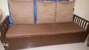 Brown color wooden sofa with 3 cushions in very