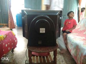 CRT Television With Brown Wooden TV Stand