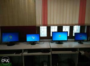 Four Flat Screen Computer Monitors with UPS and core2duo
