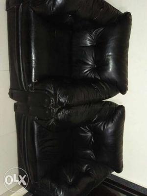 Two Tufted Black Leather Sofa Chairs