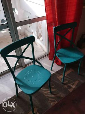 A pair of metal chairs. totally new. blue teal.