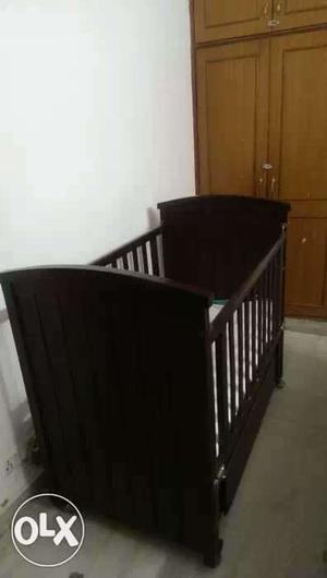 A wooden cot in very good condition with
