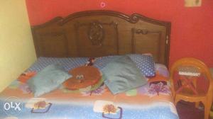 Brown Wooden Bed With Teal And Orange Bedspread