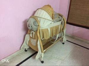 Comfortable baby cot with a swing & wheels