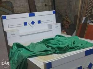 Green Textile On White And Blue Wooden Bed
