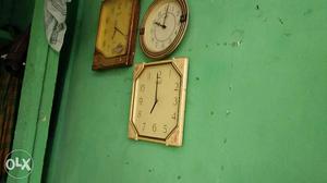 Three Brown Framed Wall Clocks