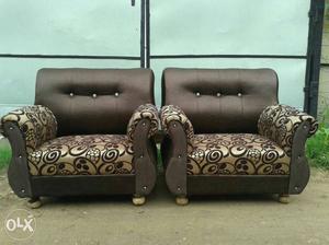 Two Brown And Black Leather Sofa Chairs