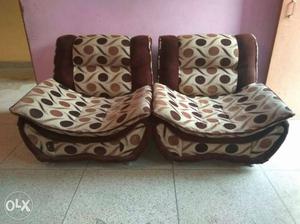 Two Brown And White Padded Sofa Chairs