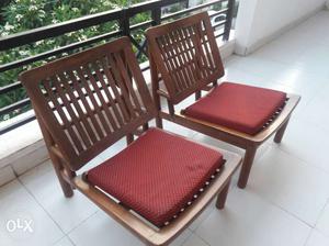 Two Wooden Base Red Padded Armless Chairs