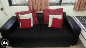 White Leather 2-seat Sofa With Red And White Throw Pillows