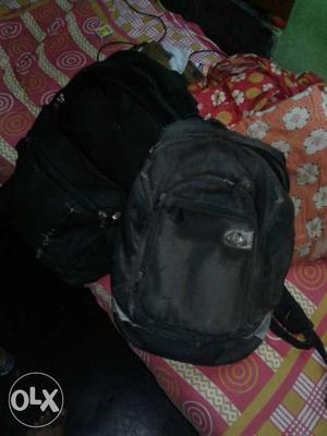 Two Black Backpacks (one hp laptop bag + one luggage bag)