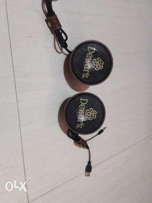 Two Round Black And Brown Dewar's Ornaments