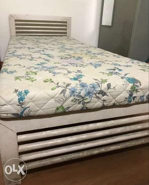 2 single beds with mattresses forming a double bed