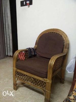 A bamboo chair with cushions. 2 such chairs