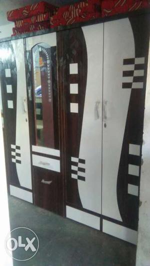 Brown And White Wooden Closet With Mirror