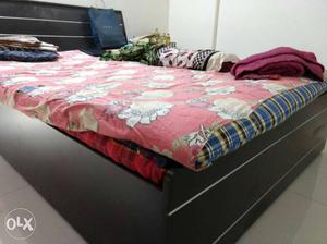 Wooden queen size bed with double mattress in