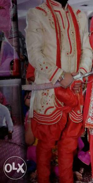 Cream and red colour sherwani only one time use
