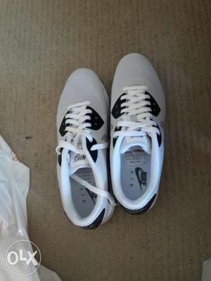 Pair Of Grey Nike Low Top Sneakers