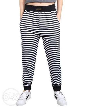 Person's White And Black Stripe Pants