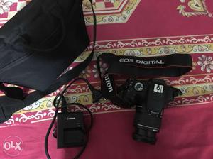 Black Canon EOS DSLR Camera With Battery Charger And Bag