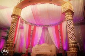 Gold-white colored wedding mandap with sofa