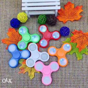 Six Green, Red, Blue, White, Orange And Pink Hand Spinners