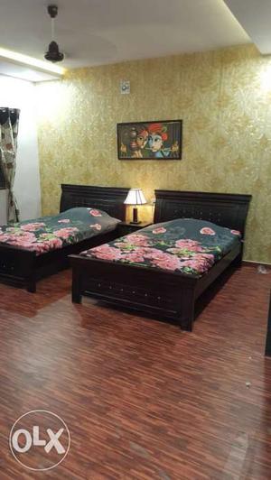 Two Black Wooden Panel Beds