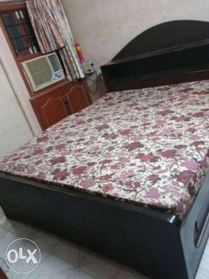 Black Wooden Bed With Pink And White Floral Mattress