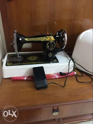 White, Yellow, And Black Sewing Machine