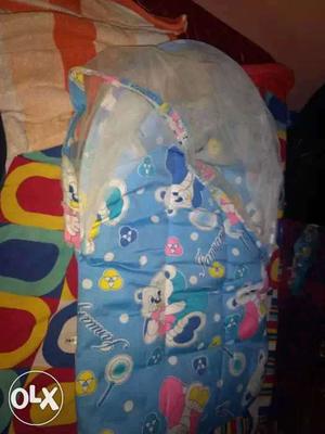 Baby's Blue And White Carrycot. Price negotiable
