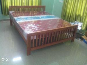 Brown Wooden Bed Frame With Red Mattress