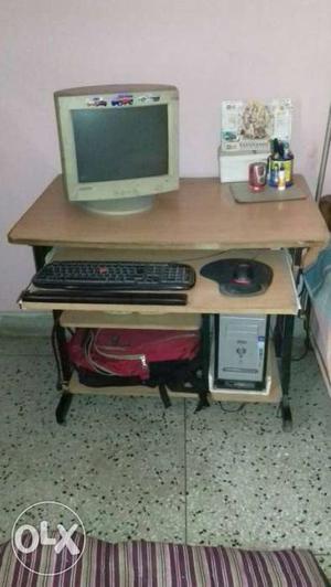 Computer along with computer table which is in a working