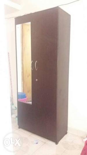 Few months old wooden two door wardrobe with mirror for sale