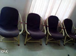 Four Brown Wooden-frame Black Padded Chairs