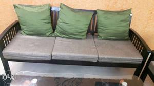 Gray Padded Sofa With Brown Wooden Base