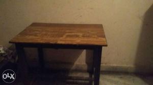 It is a wooden table, little longer in size and