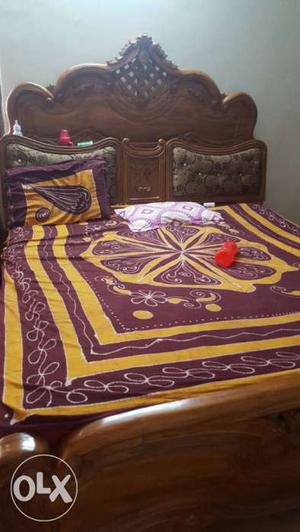 Red And Yellow Bed Blanket; Brown Wooden Bed Frame
