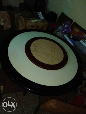 Round marble dinning table with six chairs in a
