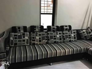 Two piece L black and grey sofa set in good