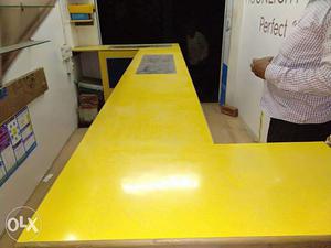 Yellow wooden counter for showroom