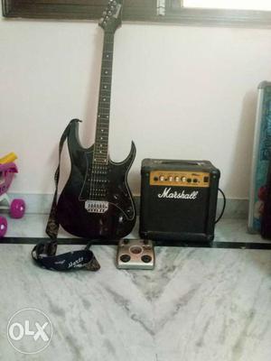 Black Ibanez Electric Guitar With Marshall Amplifier, and
