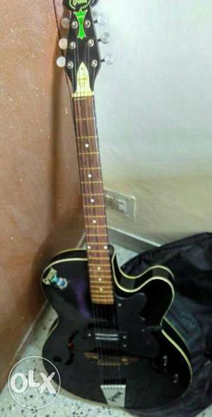 GRASON Acoustic Guitar with black cover.